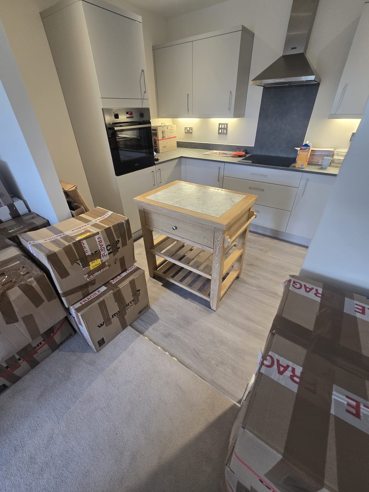 Kitchen boxes placed in the kitchen of the new flat, ready to unpack